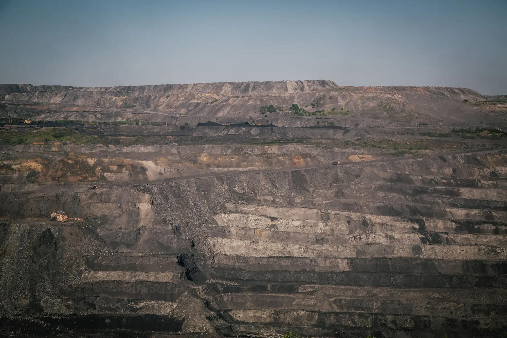 Terraced benches of an open pit coal mine seen from the rim